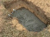 Guy anchor and cement in the pit.